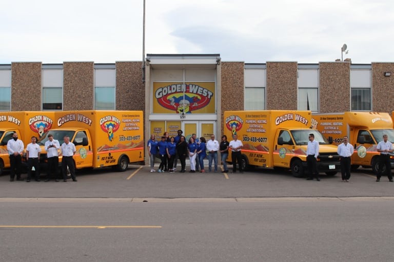 Golden West team and trucks in front of the Golden West building